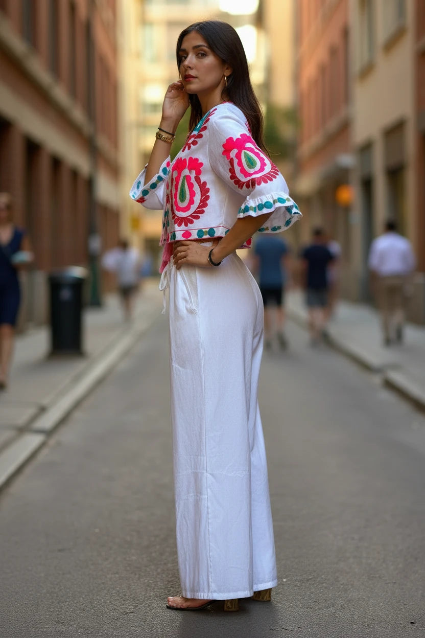 Conjunto blanco de algodón de Iciar y Candela by Creasur S.L. con top corto bordado y pantalones palazzo anchos.